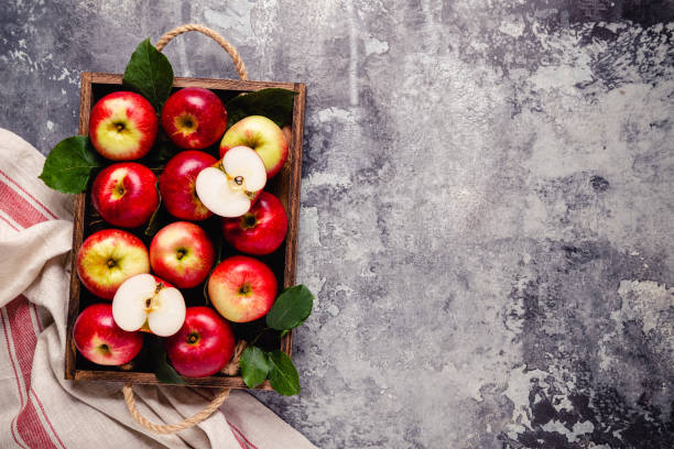 istock Ripe red apples in wooden box. 1276664984