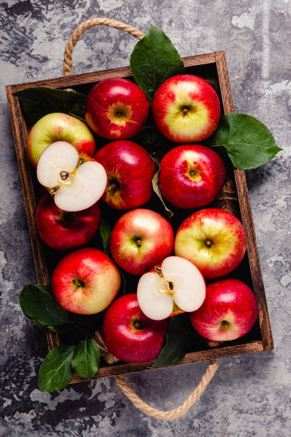 istock Ripe red apples in wooden box. 1276664992