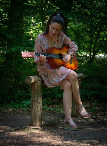 istock Woman with guitar 1276665248