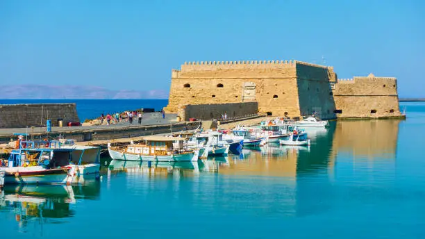 Old venetian fortress in Heraklion and fishing boats near by, Crete Island, Greece