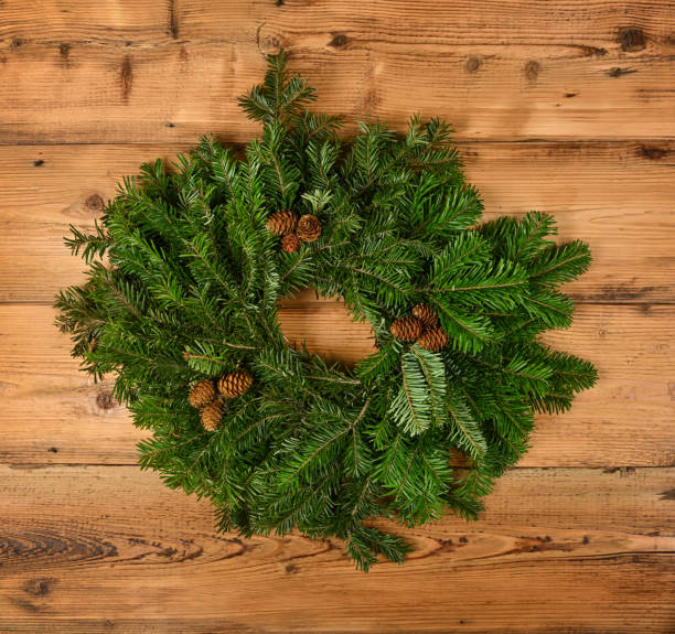 istock Close up Christmas wreath on wooden wall 1276666448