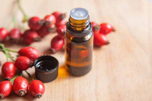 Rosehip seed essential oil in a small bottle. Selective focus.