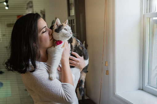 Latin woman with her cat at home