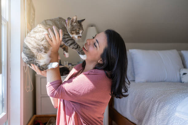 istock Latin woman with her cat at home 1276667763