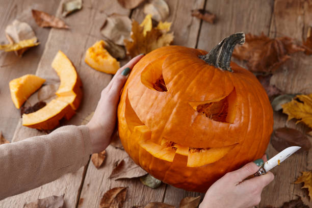 istock Cutting scary pumpkin jack for Halloween 1276669573