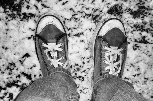 man feet and shoes in snow, Walking on a Snow. Beautiful White Winter Weather with Fresh Snowfall.