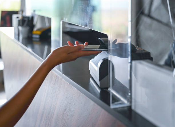 Paying wireless with smart phone Close-up of woman paying wireless with smart phone, Nikon Z7 contactless airport stock pictures, royalty-free photos & images