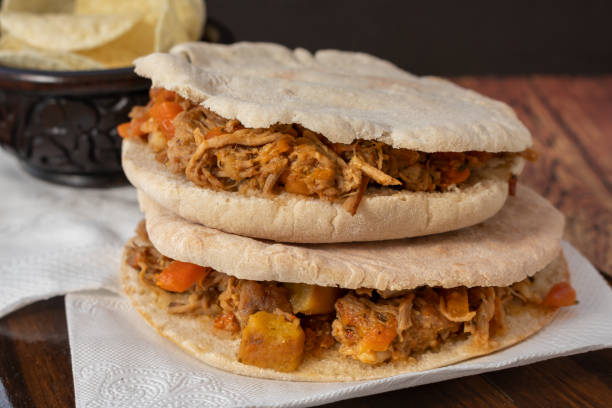 istock Barbeque Pulled Pork Sandwich with BBQ Sauce on pita bread and Fries. Rustic enviroment 1276673852