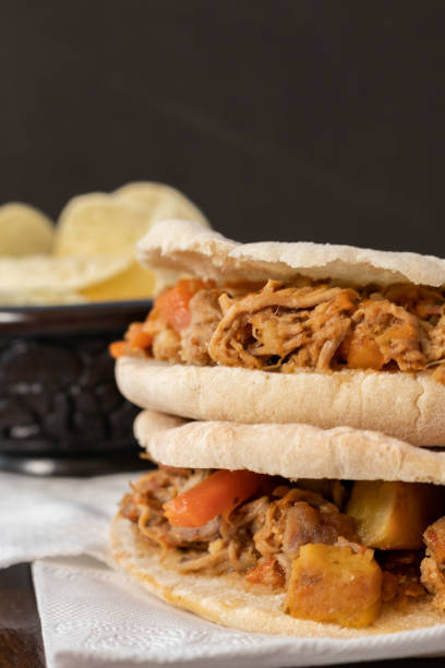 istock Barbeque Pulled Pork Sandwich with BBQ Sauce on pita bread and Fries. Rustic enviroment 1276673900