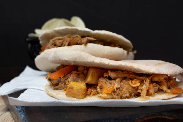 istock Barbeque Pulled Pork Sandwich with BBQ Sauce on pita bread and Fries. Rustic enviroment 1276673934