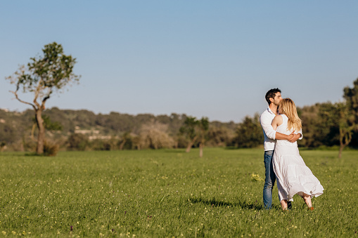 Happy young couple embracing in the nature, selective focus