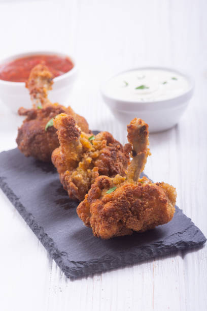 istock Chicken wings nuggets with sauces on wooden background . 1276677260