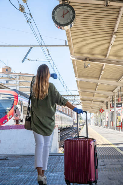 istock Anonymous female traveler in gloves walking on platform 1276678423