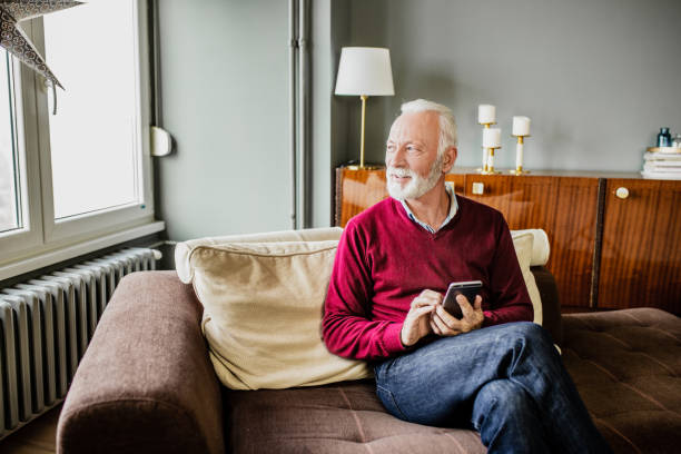 istock Senior man relaxing at home and using mobile phone 1276678502