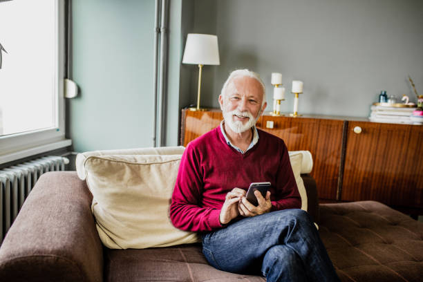 istock Senior man relaxing at home and using mobile phone 1276678525
