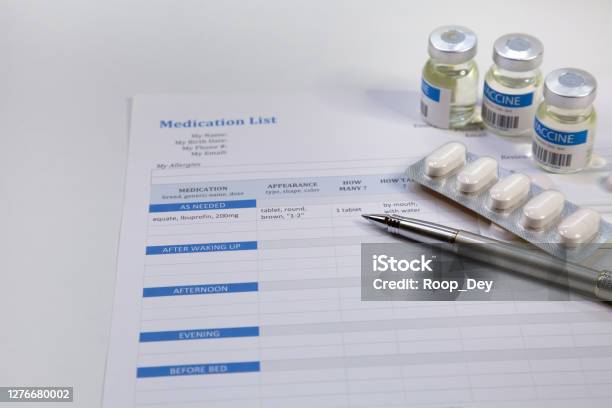 Patient Medication List With Vaccine Bottles And Medical Tablets Stock