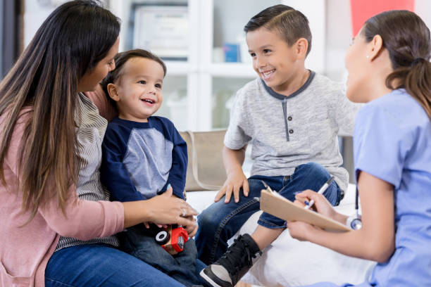istock Unrecognizable nurse smiles and laughs with brothers 1276680010