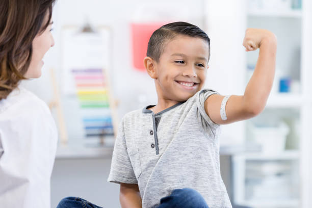 istock Unrecognizable doctor watches boy flex arm muscles 1276680037