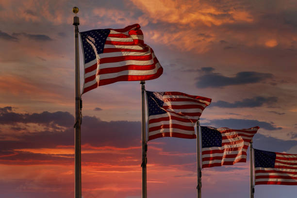 istock American flag backlit by waving large during scenic sunset 1276680608