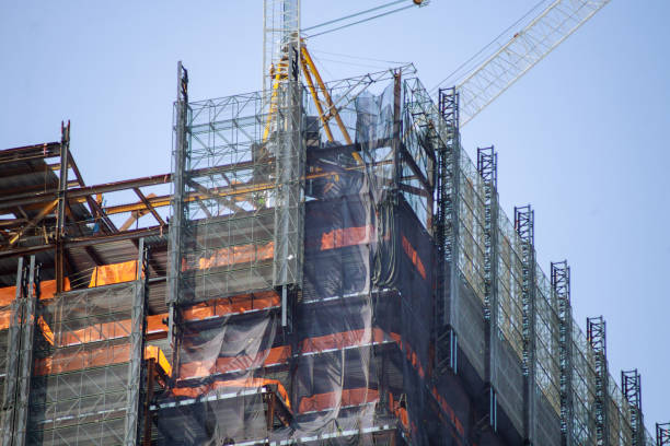 istock Residential lots building of tower construction work site with cranes with blue sky 1276680633