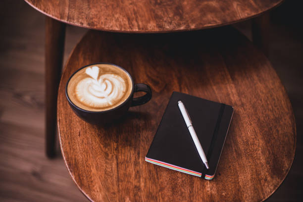 istock Coffee latte, Monstera plant and notebook on wooden table 1276681260