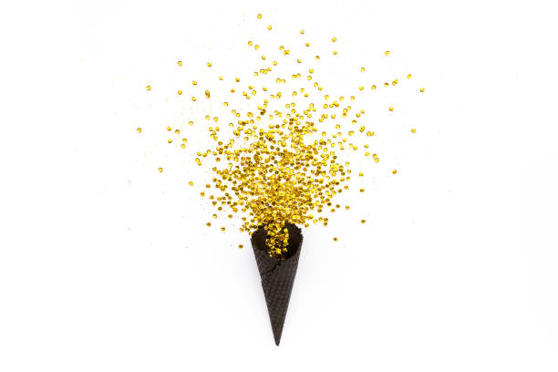 istock Black waffle cones with golden confetti tinsel isolated on white background. Flat lay, top view minimal festive concept 1276684256