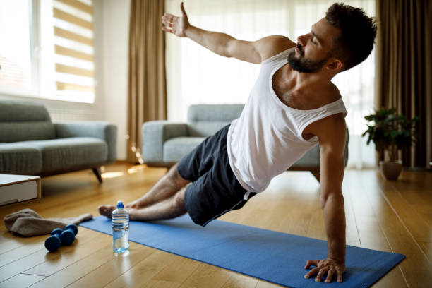 istock Strong athletic young man exercising at his home 1276685174