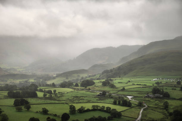 istock Stunning epic landscape image across Derwentwater valley with falling rain drifting across the mountains causing pokcets of light and dark across the countryside 1276685202
