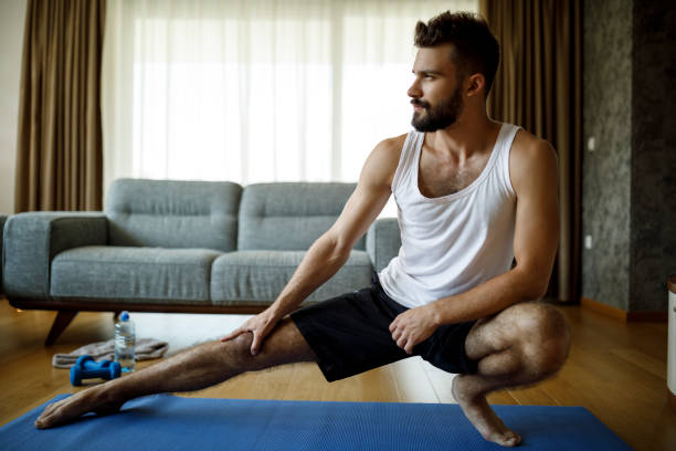 istock Strong athletic young man exercising at his home 1276685788