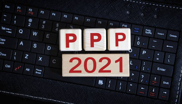 PPP 2021 concept. Wooden cubes on a black keyboard