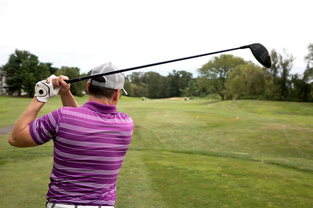istock Male Golfer completing swing hitting driver 1276686134