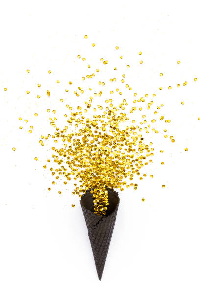 istock Black waffle cones with golden confetti tinsel isolated on white background. Flat lay, top view minimal festive concept 1276687091