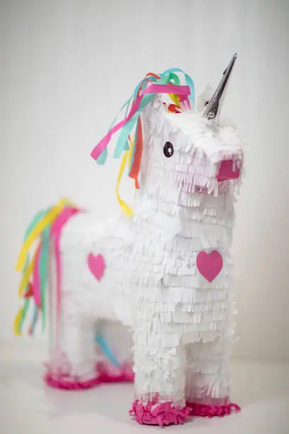 White and rainbow unicorn piñata, white background