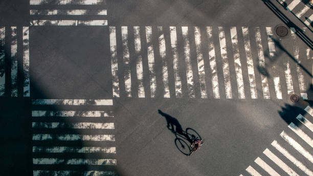 istock Elevated view over a biker man on pedestrian crossing in road intersection Japan 1276687170