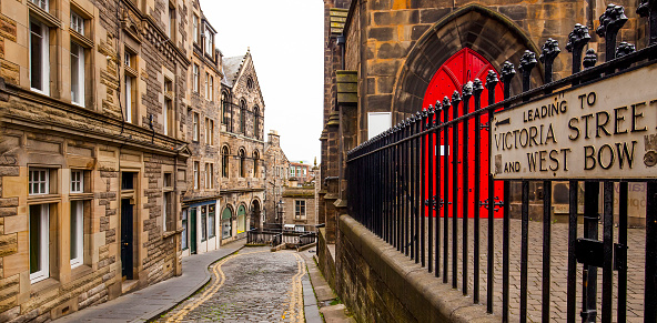 Small narrow street in Edinburgh, Scotland. Old town street leading to Victoria Street end West Bow