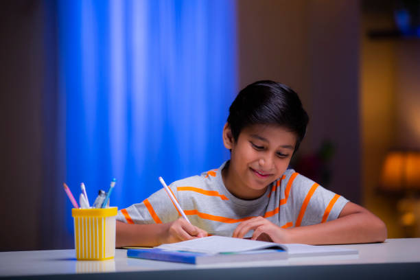 istock Boy studying at home - stock photo 1276692096