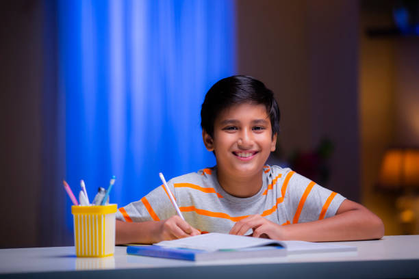 istock Boy studying at home - stock photo 1276692106