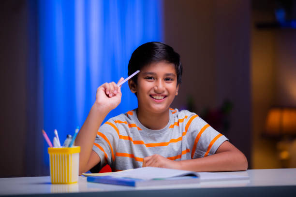 istock Boy studying at home - stock photo 1276692135