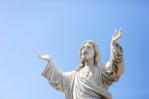 Enlightened Jesus Christ idol with arms outstretched in a welcoming manner.