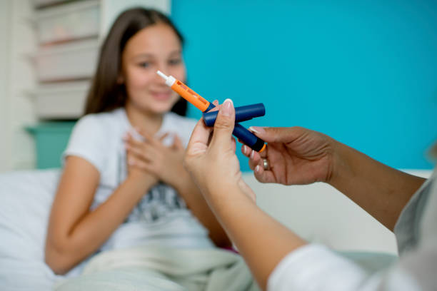 istock Young diabetic girl learning how to use insulin 1276693112