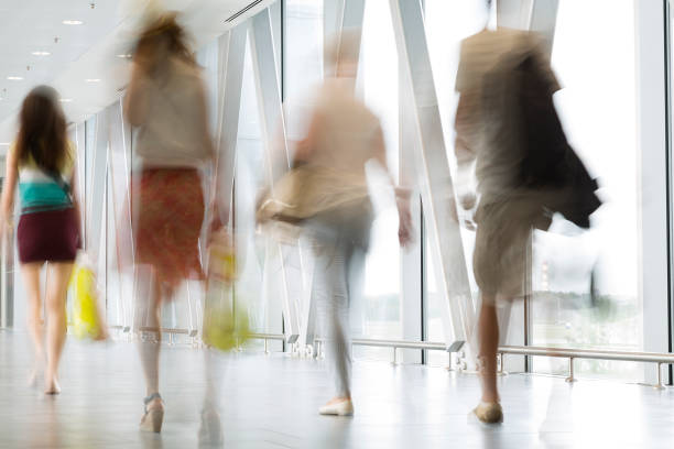 istock Group of People Walking on White Hallway, Motion Blur Effect 1276693380