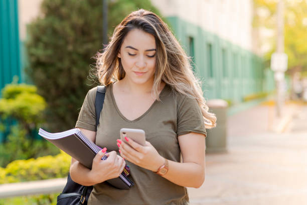 istock Young college girl walking to class. 1276694168