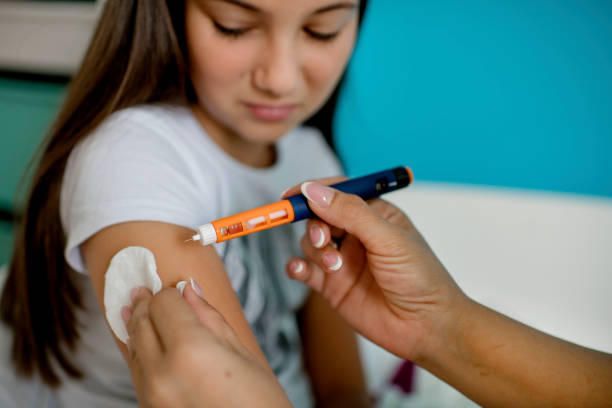 Young diabetic girl learning how to use insulin Young diabetic girl learning how to use insulin. Medical doctor supporting her. insulin\ stock pictures, royalty-free photos & images