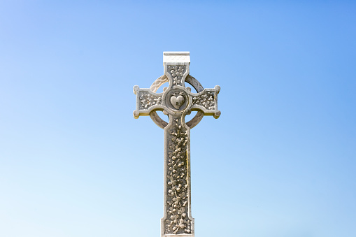 Cletic cross background. Shot in Muckross Abbey, Killarney National Park, County Kerry, Republic of Ireland. Added age effects, grain, texture. The cross is decorated with celtic knots and there is a \