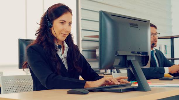 istock Business people wearing headset working in office 1276696747
