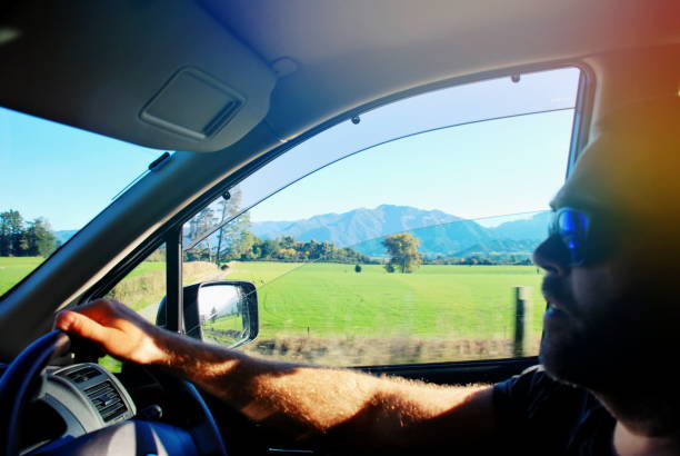 istock Man Driving Car in Rural Landscape in Summer. 1276697007