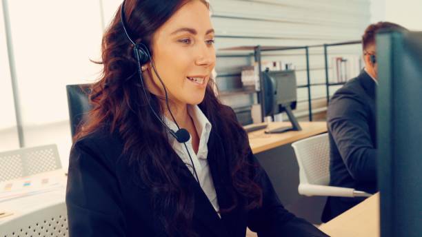istock Business people wearing headset working in office 1276697088