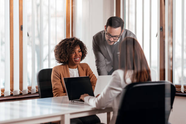 istock Young male manager helping colleagues during a meeting 1276699694