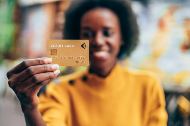 istock Woman holding a credit card 1276701145