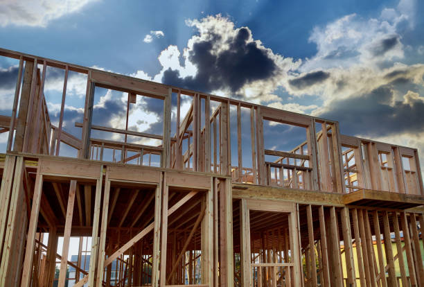 istock Framing home unfinished wood frame building or a house 1276701402